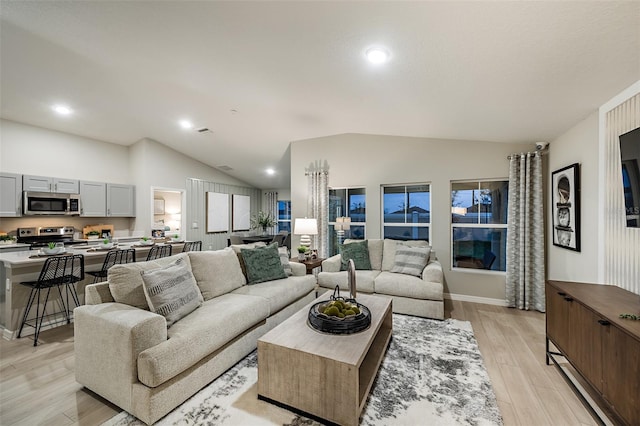 1201 Tidal St, Haines City, FL 33844 - living area with vaulted ceiling, light wood-style floors, and recessed lighting
