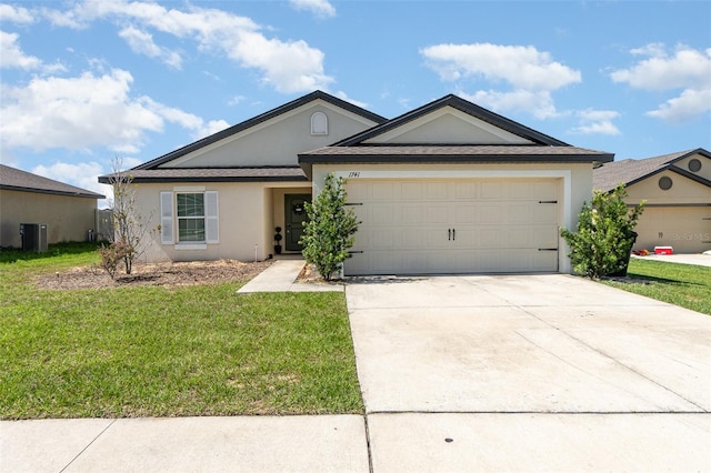 1741 Canaan Loop, Dundee, FL 33838 - ranch-style house featuring stucco siding, concrete driveway, a front lawn, and an attached garage