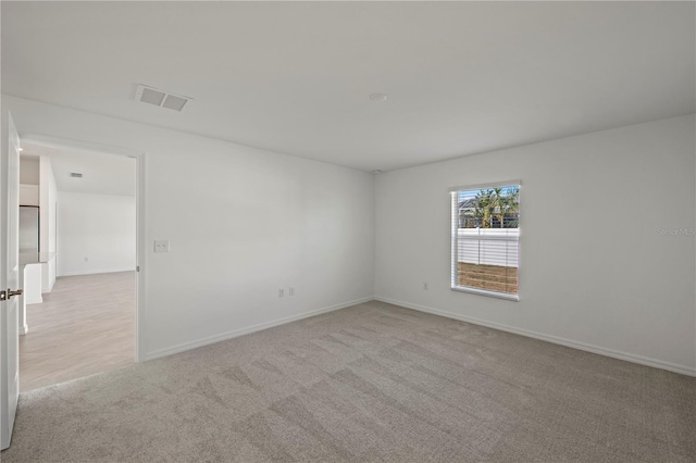 22445 Quasar Blvd, Port Charlotte, FL 33952 - spare room featuring light colored carpet and baseboards