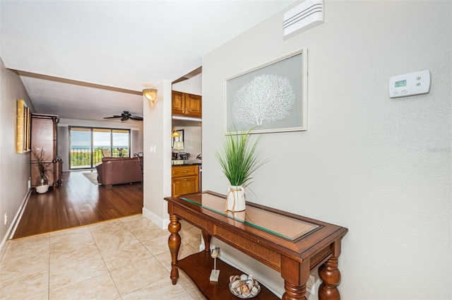 4450 Gulf Blvd Unit 110, St Pete Beach, FL 33706 - corridor featuring baseboards and light tile patterned flooring