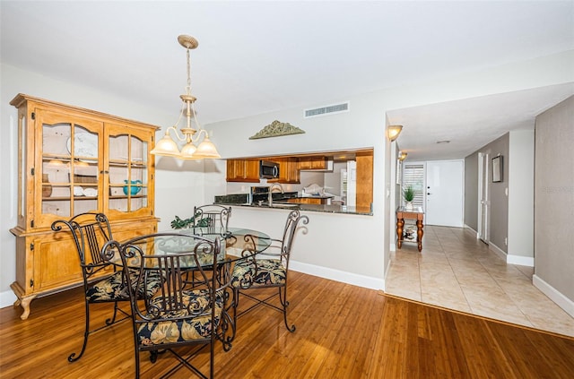 4450 Gulf Blvd Unit 110, St Pete Beach, FL 33706 - dining area with light wood-style flooring