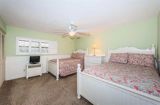 4450 Gulf Blvd Unit 110, St Pete Beach, FL 33706 - bedroom with carpet floors, wainscoting, ceiling fan, and a closet