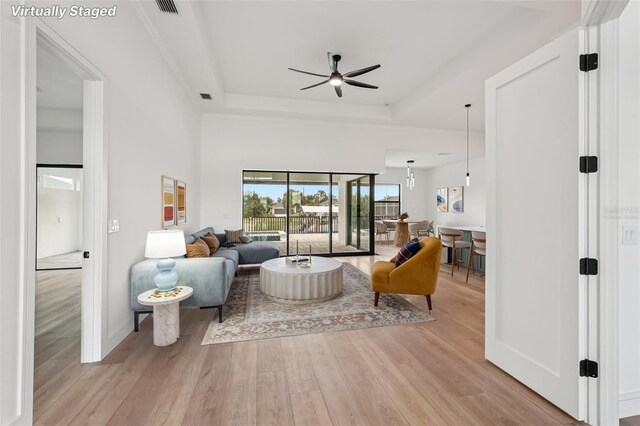 15218 Appleton Blvd, Port Charlotte, FL 33981 - living room featuring ceiling fan, a tray ceiling, and wood finished floors