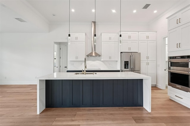 15218 Appleton Blvd, Port Charlotte, FL 33981 - kitchen featuring stainless steel appliances, crown molding, a center island with sink, light countertops, and light wood-style flooring