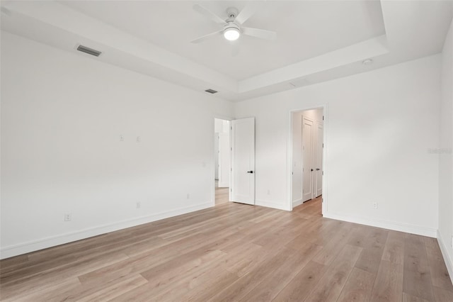 15218 Appleton Blvd, Port Charlotte, FL 33981 - empty room with a raised ceiling, light wood-type flooring, and a ceiling fan