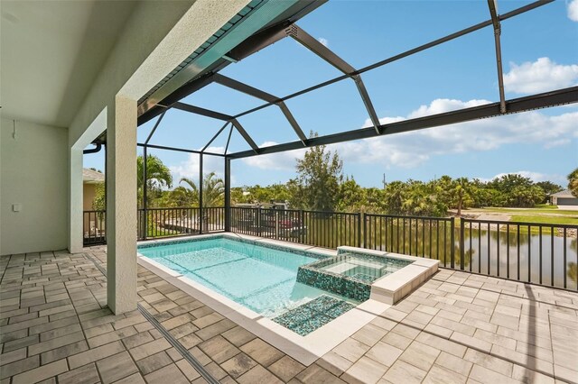 15218 Appleton Blvd, Port Charlotte, FL 33981 - view of swimming pool featuring a patio area, a pool with connected hot tub, glass enclosure, and a water view