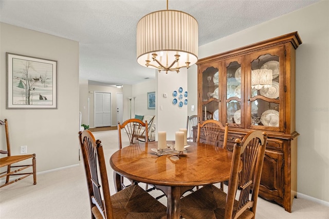 214 Caryl Way, Oldsmar, FL 34677 - dining room with light colored carpet, a chandelier, and a textured ceiling