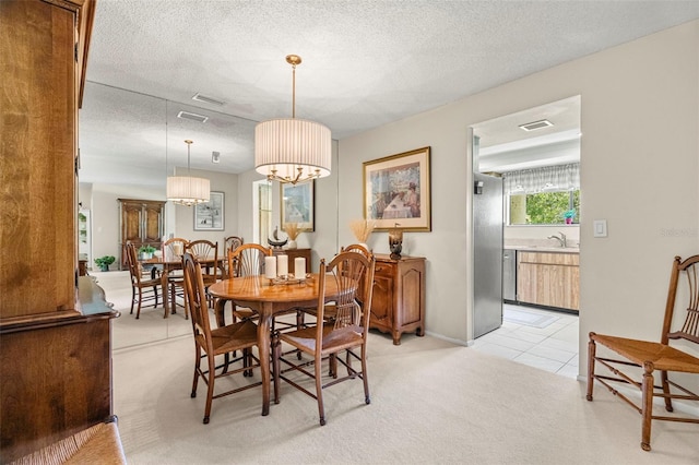 214 Caryl Way, Oldsmar, FL 34677 - dining room with light carpet, a textured ceiling, and light tile patterned flooring