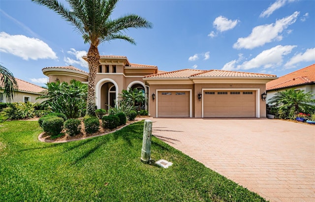 1012 Tuscany Dr, Trinity, FL 34655 - mediterranean / spanish home with a garage, stucco siding, a front yard, and decorative driveway