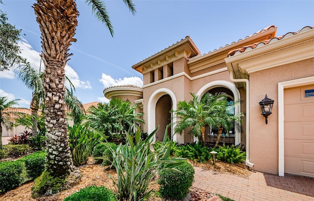 1012 Tuscany Dr, Trinity, FL 34655 - view of exterior entry featuring stucco siding