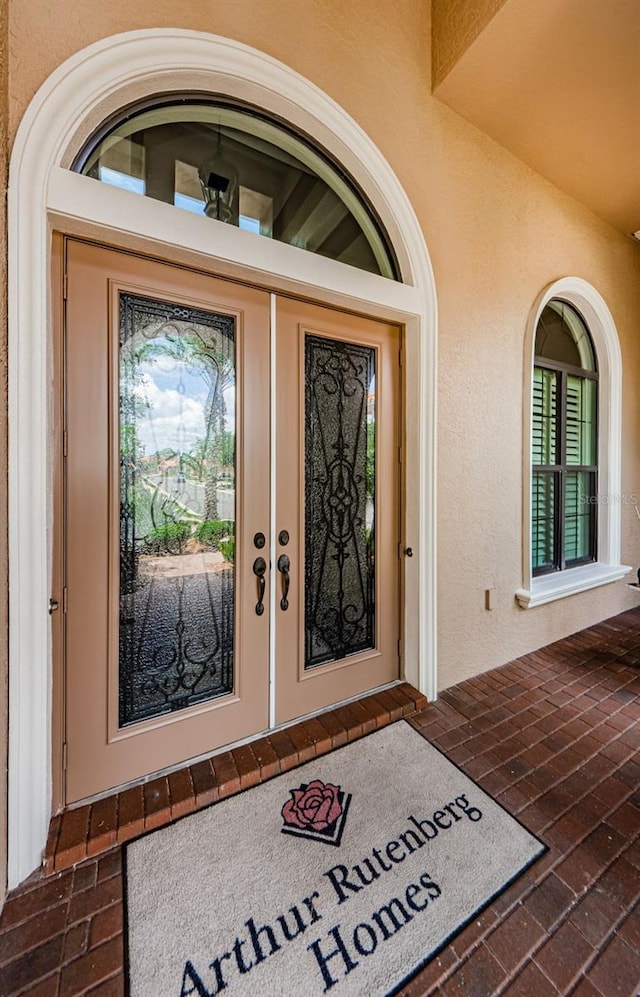 1012 Tuscany Dr, Trinity, FL 34655 - entrance to property featuring stucco siding and covered porch