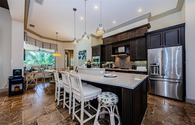 1012 Tuscany Dr, Trinity, FL 34655 - kitchen with appliances with stainless steel finishes, crown molding, stone tile flooring, tasteful backsplash, and a large island