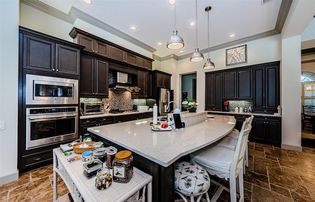 1012 Tuscany Dr, Trinity, FL 34655 - kitchen featuring stainless steel appliances, crown molding, ventilation hood, an island with sink, and stone tile floors