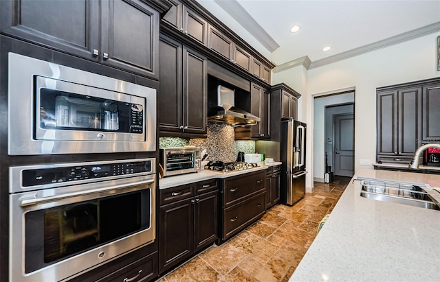 1012 Tuscany Dr, Trinity, FL 34655 - kitchen featuring appliances with stainless steel finishes, stone tile floors, backsplash, light countertops, and crown molding