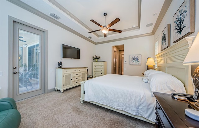 1012 Tuscany Dr, Trinity, FL 34655 - carpeted bedroom featuring a tray ceiling, access to outside, ornamental molding, a ceiling fan, and multiple windows