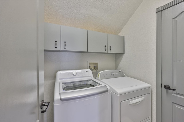 3633 Springville Dr, Valrico, FL 33596 - laundry area featuring washing machine and clothes dryer, cabinet space, and a textured ceiling