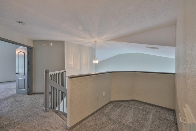 3633 Springville Dr, Valrico, FL 33596 - hallway featuring carpet flooring, an upstairs landing, a textured ceiling, a chandelier, and a textured wall