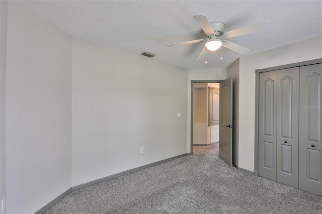 3633 Springville Dr, Valrico, FL 33596 - unfurnished bedroom with light colored carpet, baseboards, a closet, a ceiling fan, and a textured ceiling