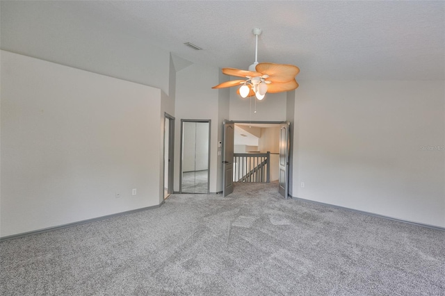 3633 Springville Dr, Valrico, FL 33596 - spare room with carpet flooring, high vaulted ceiling, a ceiling fan, a textured ceiling, and baseboards