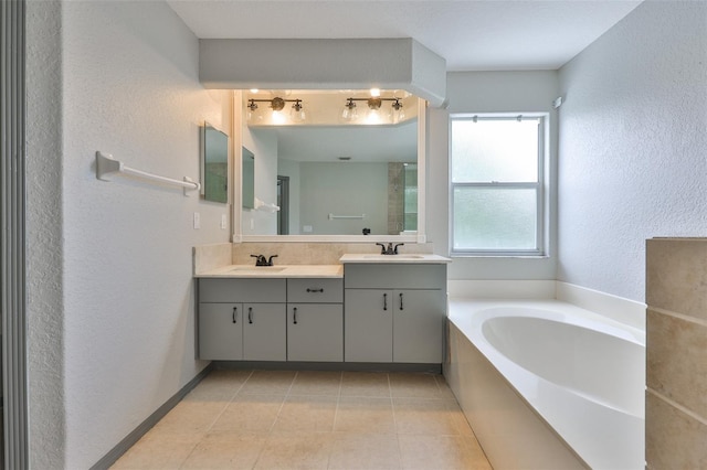 3633 Springville Dr, Valrico, FL 33596 - full bath with a bath, double vanity, a textured wall, and tile patterned flooring