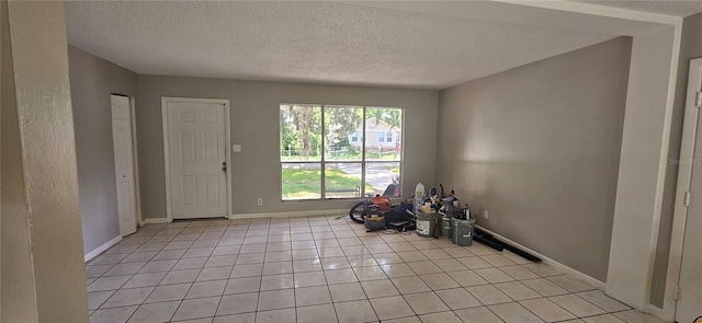 2503 Elm St, Seffner, FL 33584 - entryway featuring light tile patterned floors, baseboards, and a textured ceiling