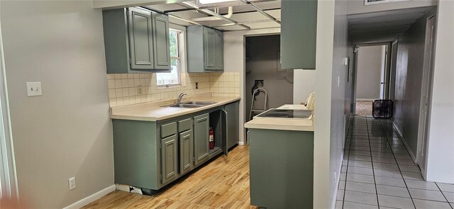 2503 Elm St, Seffner, FL 33584 - kitchen with green cabinets, a sink, light countertops, tasteful backsplash, and baseboards