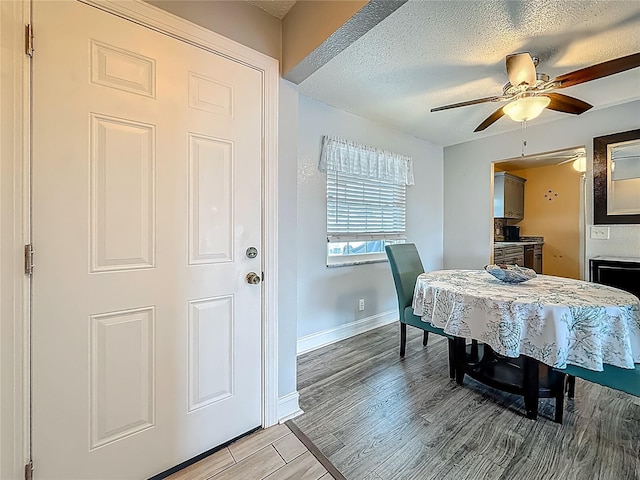 200 Country Club Dr Unit 202, Largo, FL 33771 - dining room featuring ceiling fan, a textured ceiling, baseboards, and light wood-style flooring