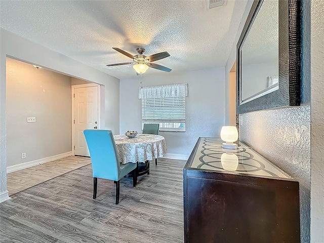 200 Country Club Dr Unit 202, Largo, FL 33771 - dining room with a ceiling fan, baseboards, wood finished floors, and a textured ceiling