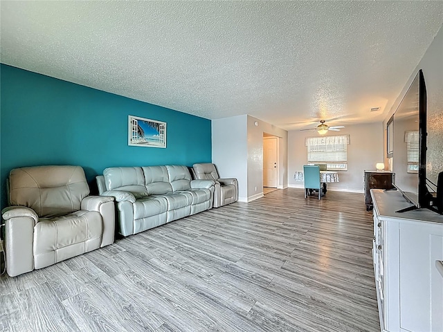 200 Country Club Dr Unit 202, Largo, FL 33771 - living area featuring a textured ceiling, wood finished floors, a ceiling fan, and baseboards