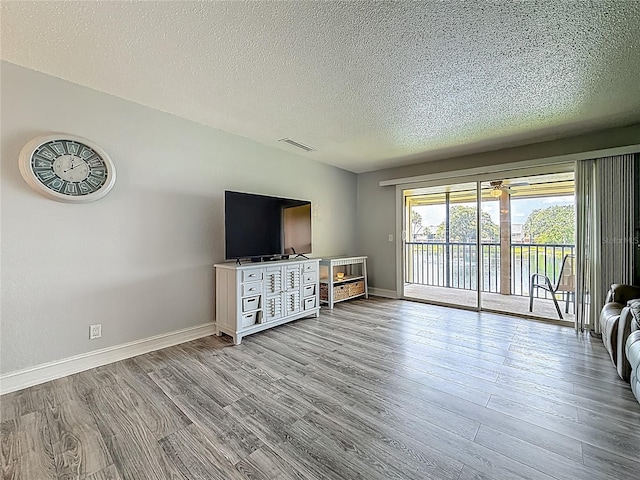 200 Country Club Dr Unit 202, Largo, FL 33771 - living area with wood finished floors, a textured ceiling, and baseboards