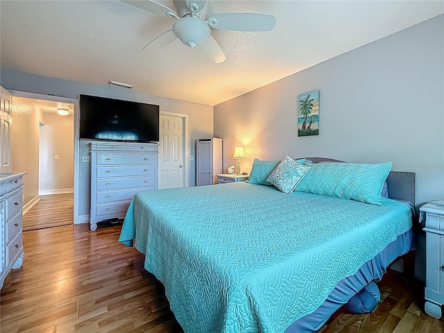200 Country Club Dr Unit 202, Largo, FL 33771 - bedroom featuring wood finished floors, a textured ceiling, a ceiling fan, and a closet