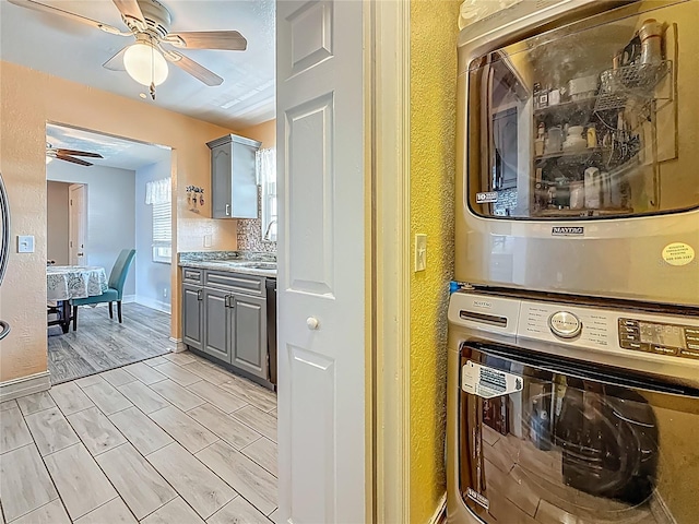 200 Country Club Dr Unit 202, Largo, FL 33771 - laundry area with estacked washer and dryer, a ceiling fan, and a textured wall