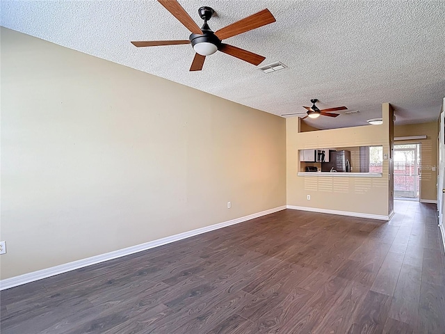 12464 Berkeley Square Dr, Tampa, FL 33626 - unfurnished living room with a ceiling fan, a textured ceiling, and dark wood-style flooring