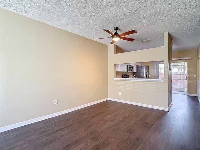 12464 Berkeley Square Dr, Tampa, FL 33626 - unfurnished living room with ceiling fan, dark wood finished floors, and a textured ceiling