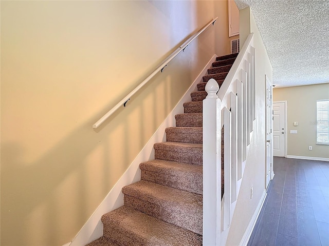 12464 Berkeley Square Dr, Tampa, FL 33626 - stairway featuring a textured ceiling