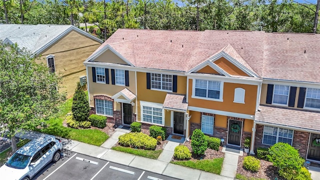 12464 Berkeley Square Dr, Tampa, FL 33626 - townhome / multi-family property with stucco siding, uncovered parking, and roof with shingles