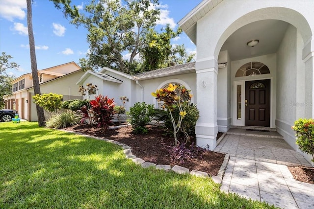 6051 65th Ave N, Pinellas Park, FL 33781 - view of exterior entry featuring a yard and stucco siding