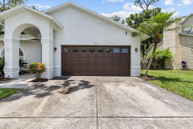 6051 65th Ave N, Pinellas Park, FL 33781 - view of front of home featuring an attached garage, stucco siding, and driveway