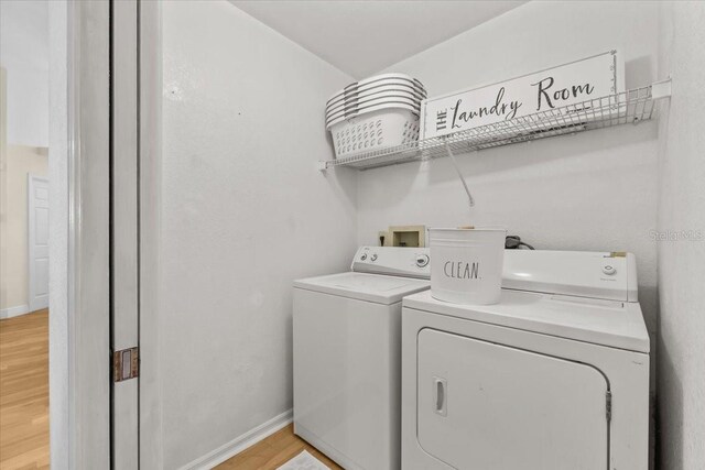 6051 65th Ave N, Pinellas Park, FL 33781 - washroom with washer and clothes dryer and light wood-type flooring