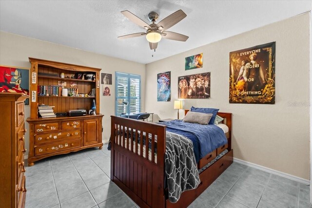 6051 65th Ave N, Pinellas Park, FL 33781 - bedroom with light tile patterned floors and ceiling fan