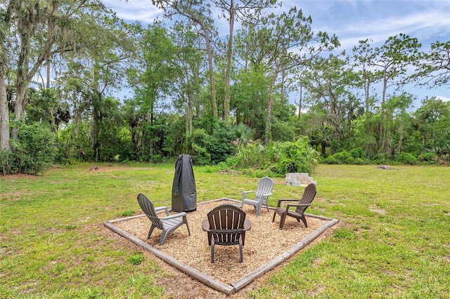 3371 N Bay Ave, Crystal River, FL 34428 - view of grassy yard featuring an outdoor fire pit