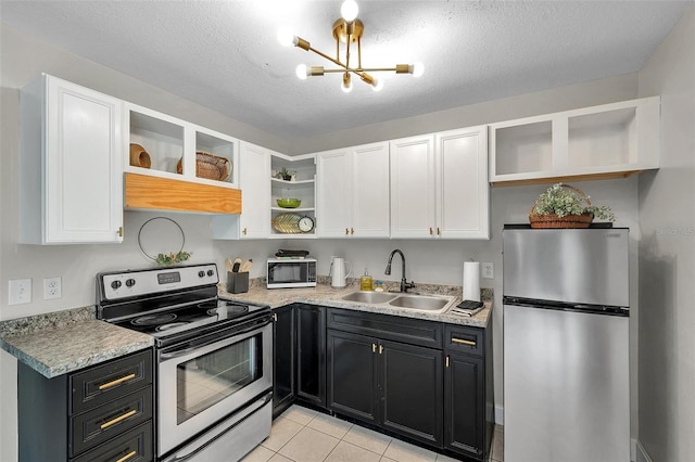 3371 N Bay Ave, Crystal River, FL 34428 - kitchen with open shelves, appliances with stainless steel finishes, white cabinetry, a chandelier, and light countertops
