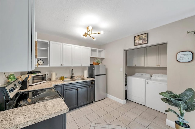 3371 N Bay Ave, Crystal River, FL 34428 - kitchen with appliances with stainless steel finishes, washing machine and dryer, open shelves, light countertops, and light tile patterned floors
