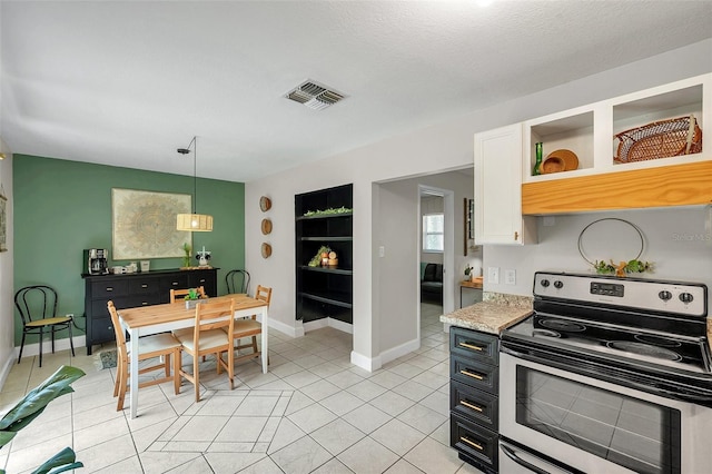 3371 N Bay Ave, Crystal River, FL 34428 - kitchen featuring stainless steel electric range, light countertops, open shelves, light tile patterned floors, and hanging light fixtures