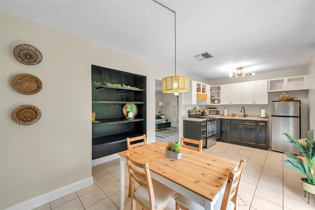 3371 N Bay Ave, Crystal River, FL 34428 - dining space featuring light tile patterned floors and a chandelier