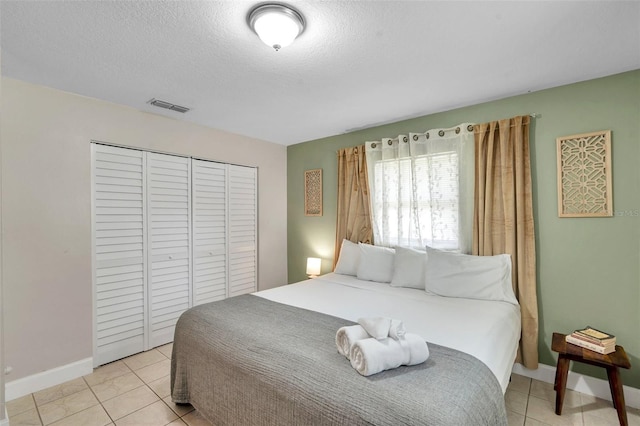 3371 N Bay Ave, Crystal River, FL 34428 - bedroom featuring light tile patterned flooring, a closet, and a textured ceiling