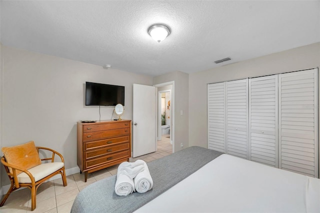 3371 N Bay Ave, Crystal River, FL 34428 - bedroom with light tile patterned floors, a textured ceiling, and a closet