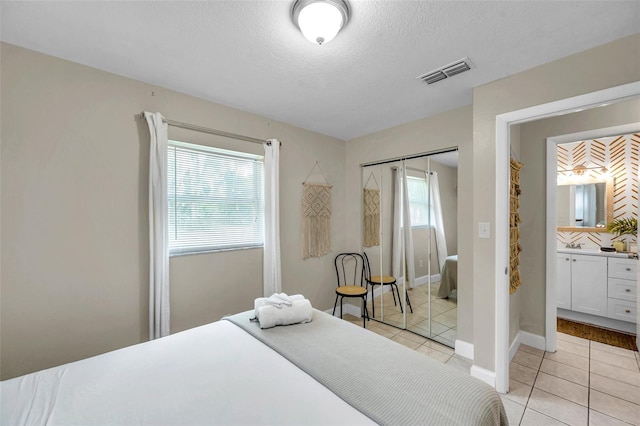 3371 N Bay Ave, Crystal River, FL 34428 - bedroom featuring light tile patterned flooring, a closet, and a textured ceiling