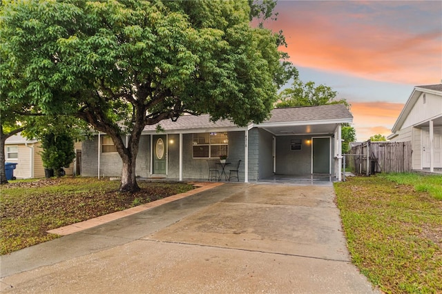 4318 Mesa Dr, New Port Richey, FL 34653 - view of front of home with concrete driveway, a carport, and roof with shingles