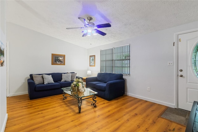 4318 Mesa Dr, New Port Richey, FL 34653 - living area featuring ceiling fan, light wood-style flooring, a textured ceiling, plenty of natural light, and lofted ceiling